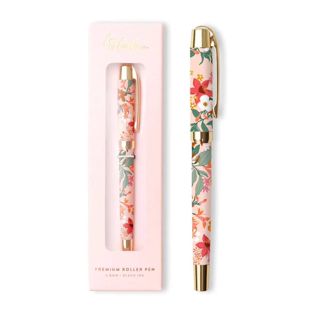 Stylo rose pastel avec dessin de fleurs blanches, roses et vertes